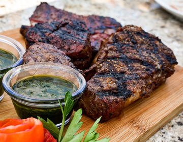 Denver Steak on cutting board with chimichurri