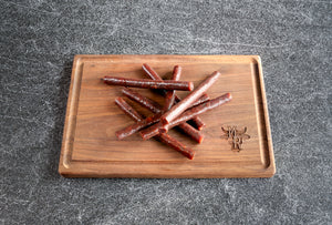 Wagyu Jalapeno Cheddar Snack Sticks from Marble Ridge Farms on a cutting board