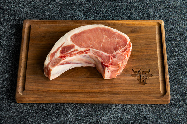 Angled view of a Marble Ridge Farms Bone-in Center Cut Pork Chop